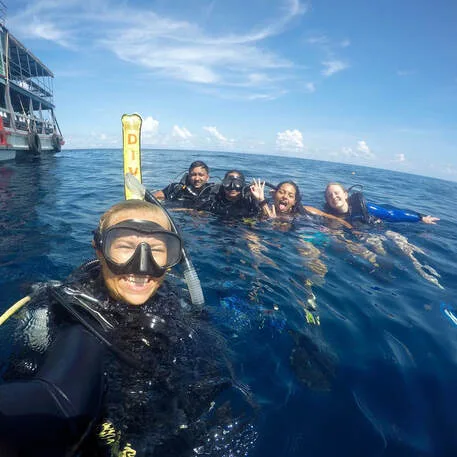Scuba Instructor Sanne and her PADI open Water students on the surface at Shark Island